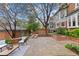 Spacious backyard with stone patio, lounge furniture, mature trees, garden, and a fire pit perfect for outdoor gatherings at 963 N Lafayette St, Denver, CO 80218