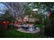 Charming backyard patio area with outdoor seating and fire pit, surrounded by mature trees and lush landscaping at 963 N Lafayette St, Denver, CO 80218
