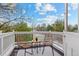 Charming balcony featuring two chairs, a small table, and a peaceful view of the surrounding greenery at 963 N Lafayette St, Denver, CO 80218