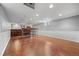 Finished basement boasting a wet bar, wood flooring, and neutral paint, perfect for entertaining and relaxing at 963 N Lafayette St, Denver, CO 80218