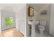 Charming bathroom with a pedestal sink, tiled floor, and bright window at 963 N Lafayette St, Denver, CO 80218