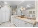 Bright bathroom with double sinks, marble countertops, a glass-enclosed shower and modern fixtures at 963 N Lafayette St, Denver, CO 80218