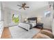 Bright bedroom with a large window, a ceiling fan, and a gray upholstered headboard at 963 N Lafayette St, Denver, CO 80218