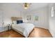 Bright bedroom with a comfortable bed, ample natural light, and hardwood floors at 963 N Lafayette St, Denver, CO 80218