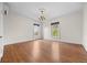 Spacious bedroom featuring hardwood floors, two windows with views, and a decorative chandelier at 963 N Lafayette St, Denver, CO 80218