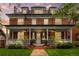 Charming two-story red brick home with a welcoming front porch and meticulously maintained landscaping at 963 N Lafayette St, Denver, CO 80218