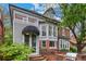 Charming home with brick and siding exterior, bay windows, white trim, and a front entrance with an awning at 963 N Lafayette St, Denver, CO 80218