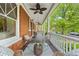 Inviting front porch featuring comfortable seating, ceiling fans, and classic white railings at 963 N Lafayette St, Denver, CO 80218