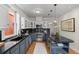 Modern kitchen featuring stainless steel appliances, granite countertops, and custom blue and white cabinetry at 963 N Lafayette St, Denver, CO 80218