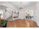 Bright living room with hardwood floors, staircase, decorative chandelier, and elegant archway at 963 N Lafayette St, Denver, CO 80218