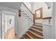 Elegant staircase with wood treads, white risers, and decorative wood trim at 963 N Lafayette St, Denver, CO 80218