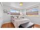 This bedroom features wood floors, neutral walls, and bright light at 816 Forest St, Denver, CO 80220