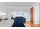Bright bedroom with hardwood floors, a loveseat and neutral walls at 816 Forest St, Denver, CO 80220