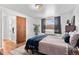 Cozy bedroom features a full bed with decorative pillows and bedding, plus neutral walls at 816 Forest St, Denver, CO 80220