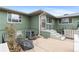 Outdoor patio featuring a pair of egg chairs with an emerald green house in the background at 816 Forest St, Denver, CO 80220