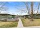 Inviting green condo building with well-kept lawns and walkways on a sunny day at 816 Forest St, Denver, CO 80220