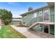 Two-story home, with stairs leading to the front door and green lawn surrounding the house at 816 Forest St, Denver, CO 80220