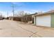 View of the exterior of the garage with a driveway and alley at 816 Forest St, Denver, CO 80220