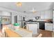 Charming eat-in kitchen features stainless steel appliances and white cabinetry at 816 Forest St, Denver, CO 80220