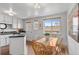 Well-lit eat-in kitchen with island, modern appliances, and white cabinets at 816 Forest St, Denver, CO 80220