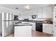 Bright kitchen with white cabinets, stainless steel refrigerator and black appliances at 816 Forest St, Denver, CO 80220