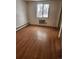 Empty bedroom with wood floors, window and closet at 1304 S Parker Rd # 359, Denver, CO 80231