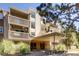 Multi-level condo building entrance featuring balconies, landscaping, and a covered entrance at 1304 S Parker Rd # 359, Denver, CO 80231