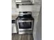 Stainless steel oven with cooktop set into white tile backsplash, below a range hood at 1304 S Parker Rd # 359, Denver, CO 80231