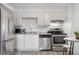Updated kitchen with stainless steel appliances and light wood-look floors at 1304 S Parker Rd # 359, Denver, CO 80231