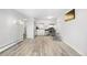 Bright living room and kitchen area with stainless steel appliances and modern light fixtures at 1304 S Parker Rd # 359, Denver, CO 80231