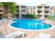 Exterior view of a communal outdoor swimming pool surrounded by lounge chairs and greenery in a landscaped area at 1304 S Parker Rd # 359, Denver, CO 80231