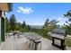Outdoor deck with grill, dining set, and scenic mountain views at 857 Pawnee Trl, Castle Rock, CO 80108