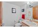 Powder room with a peach vanity and framed pictures at 857 Pawnee Trl, Castle Rock, CO 80108