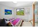 Cozy bedroom with large window overlooking greenery, complemented by colorful wall art at 857 Pawnee Trl, Castle Rock, CO 80108