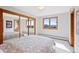 Bedroom featuring a large window with a great view, mirrored closet, and patterned bedding at 857 Pawnee Trl, Castle Rock, CO 80108