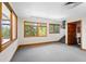 Bright bonus room with carpet, wood trim, and many windows offering views at 857 Pawnee Trl, Castle Rock, CO 80108