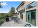 Exterior shot of the home with a grill, table, and chairs set up on the deck at 857 Pawnee Trl, Castle Rock, CO 80108