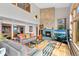 Bright living room with stone fireplace, high ceilings and large windows at 857 Pawnee Trl, Castle Rock, CO 80108
