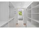 Spacious walk-in closet with white shelving and a window at the far end at 857 Pawnee Trl, Castle Rock, CO 80108