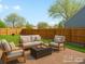 Backyard patio seating area with a well-maintained lawn and a wooden fence at 11256 W 104Th Ave, Broomfield, CO 80021