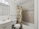 Tiled bathroom featuring a shower over tub and a vanity sink with shaker style cabinets at 11256 W 104Th Ave, Broomfield, CO 80021