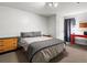 Bedroom featuring neutral decor, a wood dresser, and a bright red desk at 11256 W 104Th Ave, Broomfield, CO 80021