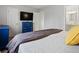 Bright bedroom featuring TV, ensuite, and a plush bedspread at 11256 W 104Th Ave, Broomfield, CO 80021