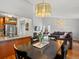 Bright dining area flowing into the living room, with hardwood floors and modern lighting fixtures at 11256 W 104Th Ave, Broomfield, CO 80021