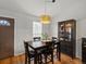 Bright dining room featuring hardwood floors, modern light fixture, and large cabinet at 11256 W 104Th Ave, Broomfield, CO 80021