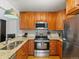 Modern kitchen with stainless steel appliances, granite countertops, and wooden cabinetry at 11256 W 104Th Ave, Broomfield, CO 80021