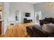 Open concept living room with hardwood floors, a comfortable couch, and sliding glass doors at 11256 W 104Th Ave, Broomfield, CO 80021