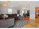 Open-concept living room with dining area, hardwood floors, and modern decor at 11256 W 104Th Ave, Broomfield, CO 80021