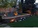A relaxing backyard with decorative lighting, a stone retaining wall, and lovely landscaping at 7946 S Pennsylvania Ct, Littleton, CO 80122