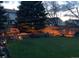 A sprawling backyard featuring a well-maintained lawn, charming garden lights, and an inviting, orange bench at 7946 S Pennsylvania Ct, Littleton, CO 80122